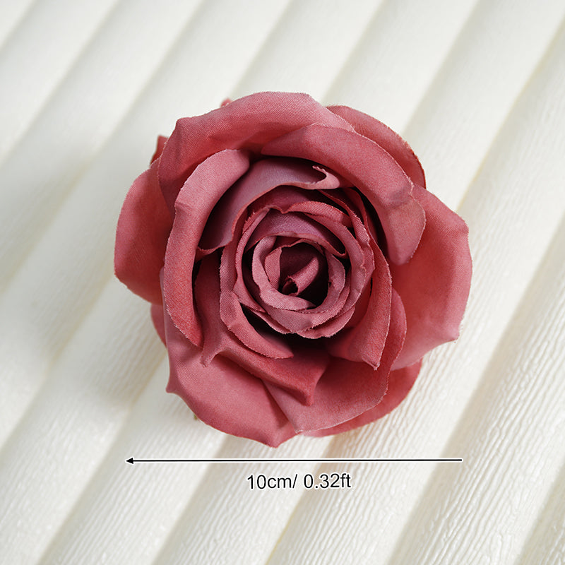 Artificial rose flower heads lace background flat lay