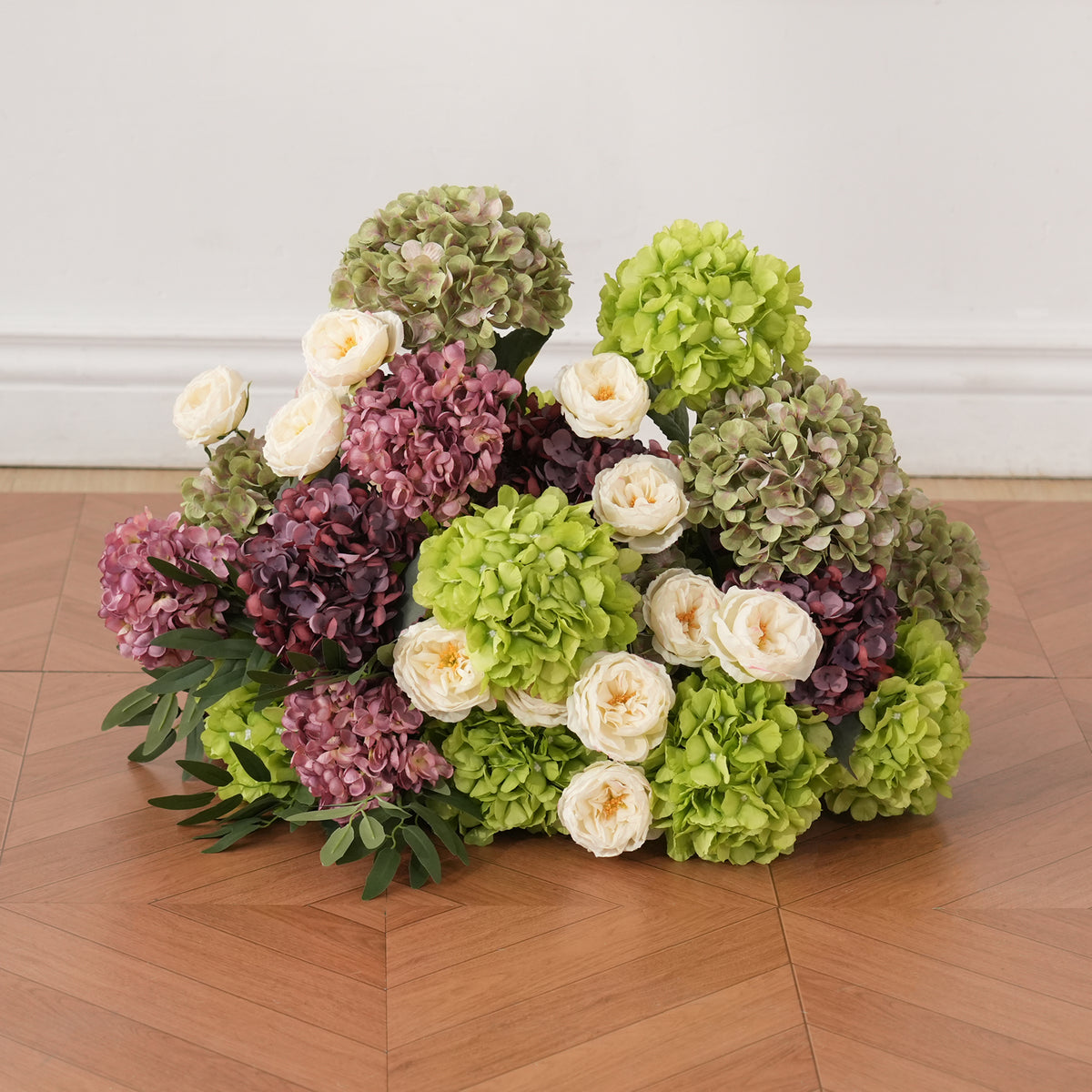 Burgundy, mauve and green floral pillar for romantic evening weddings