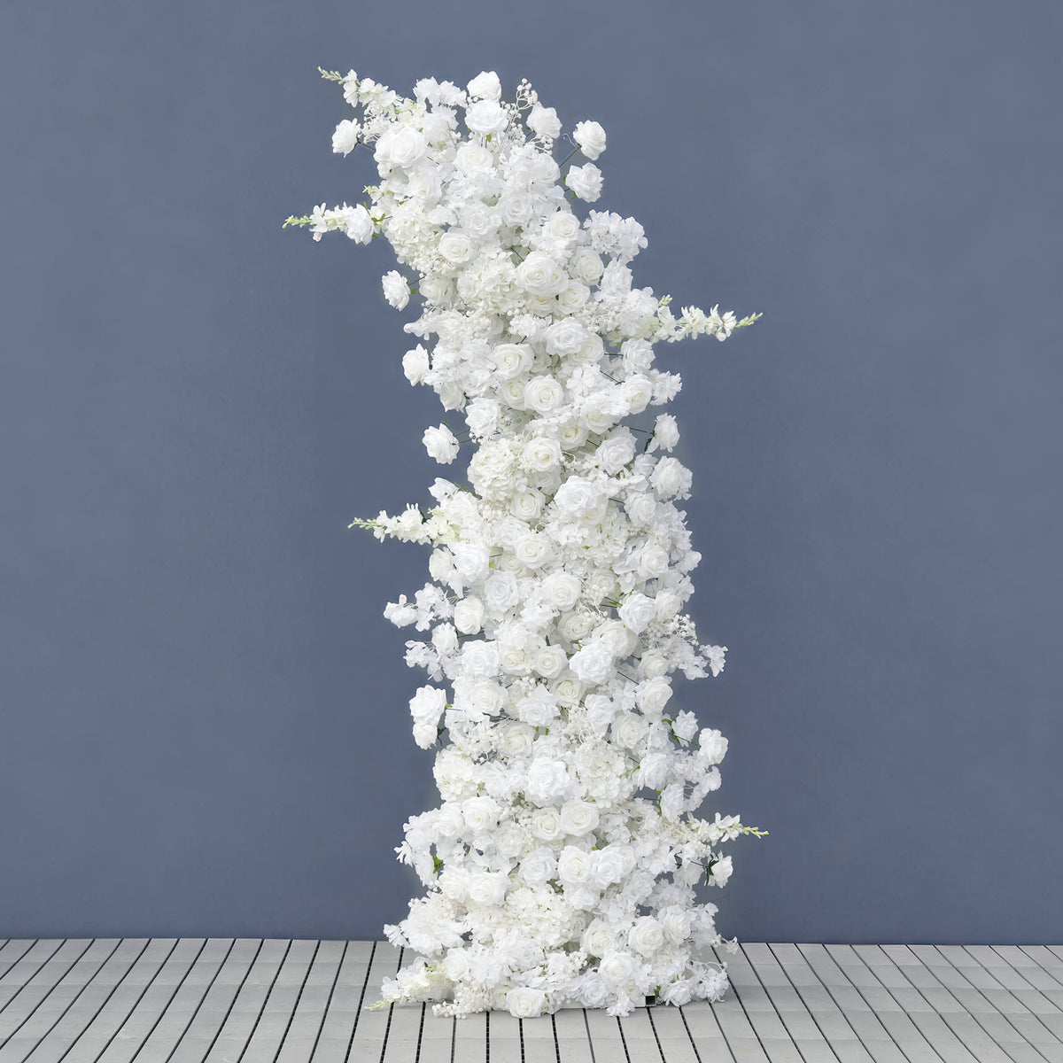 White curved flower arch displayed on gray studio backdrop