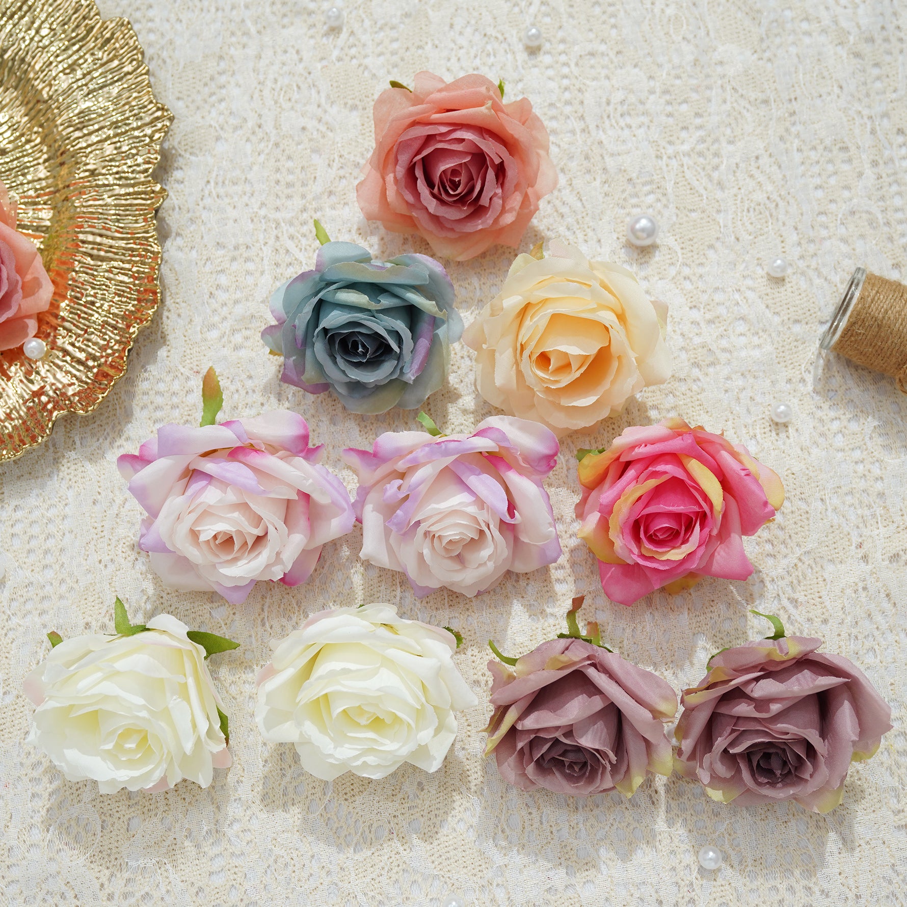 Small white faux rose heads flat lay