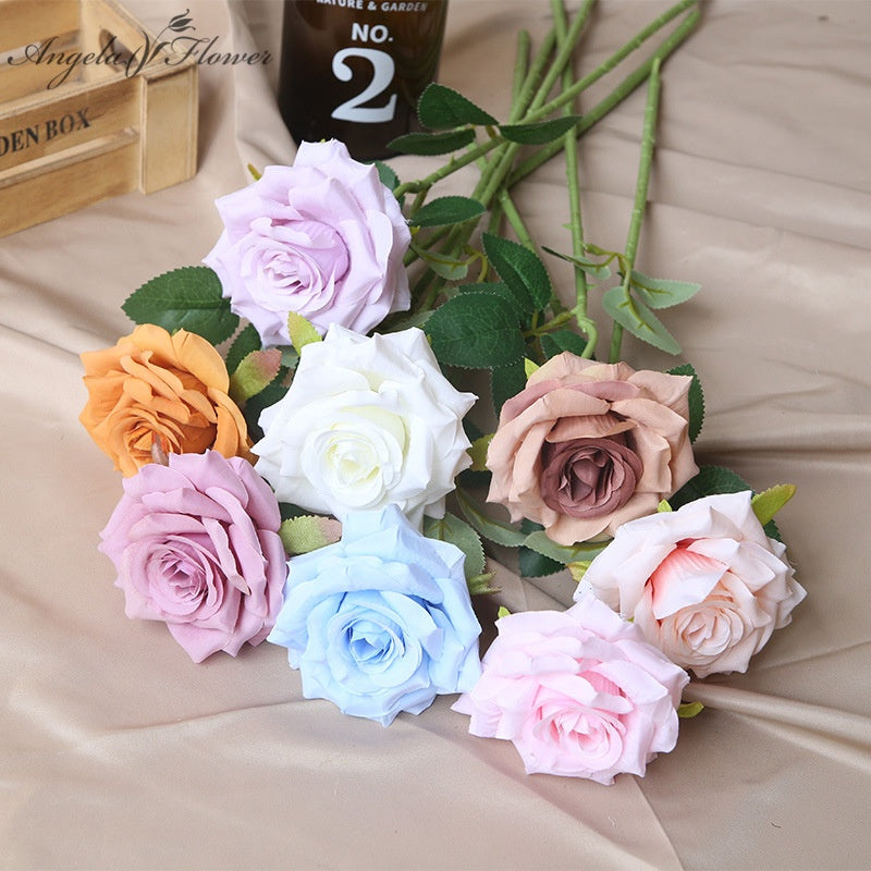 Faux rose stem with green leaves