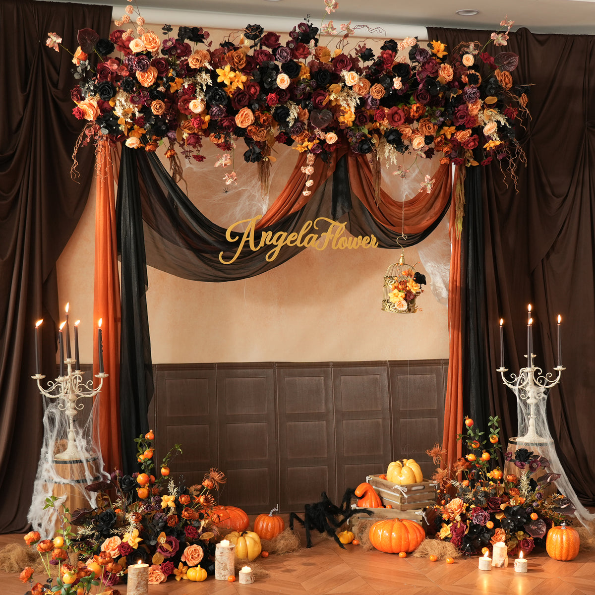Outdoor fall ceremony decor with orange black floral arch