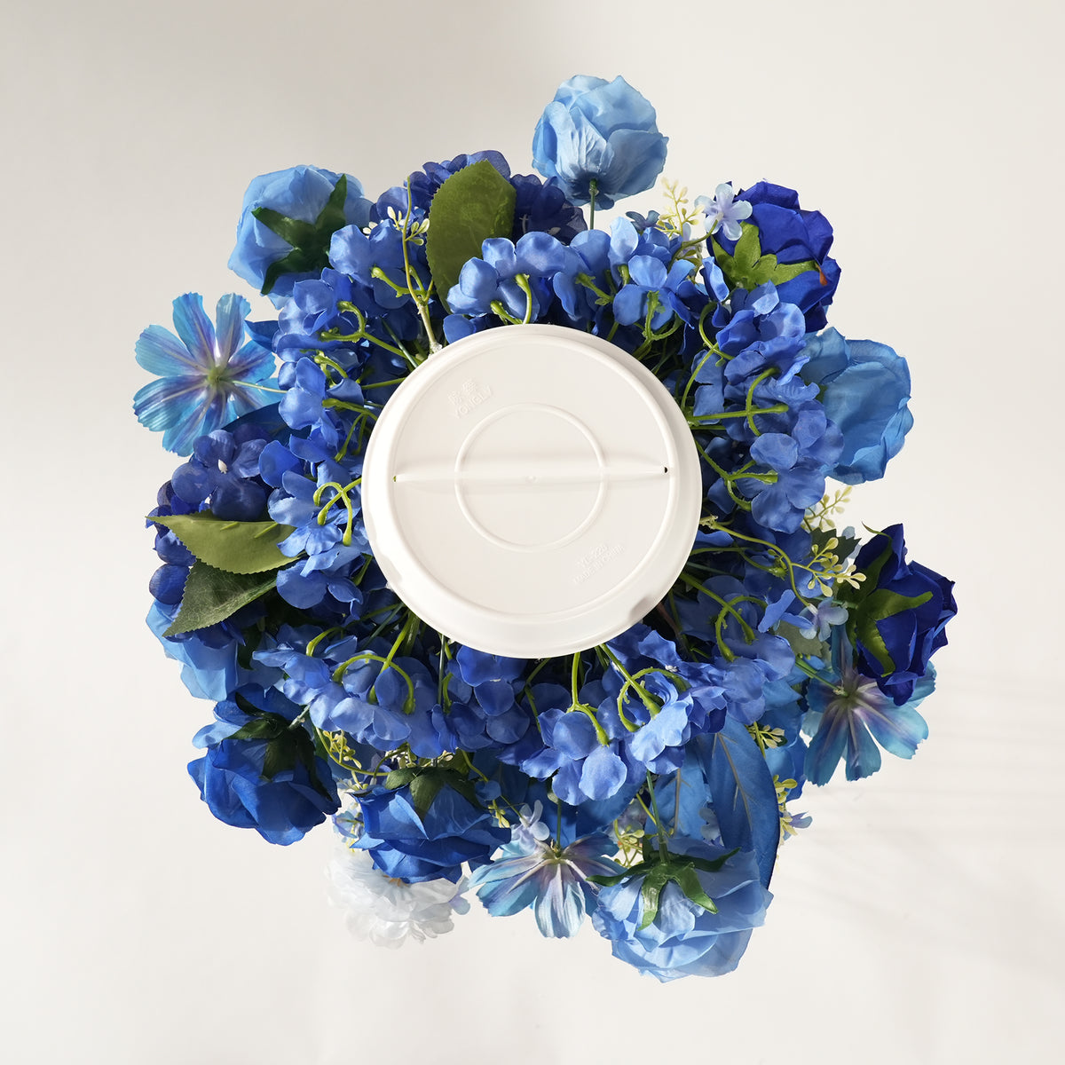 Closeup of royal blue mixed artificial flower wedding table centerpiece