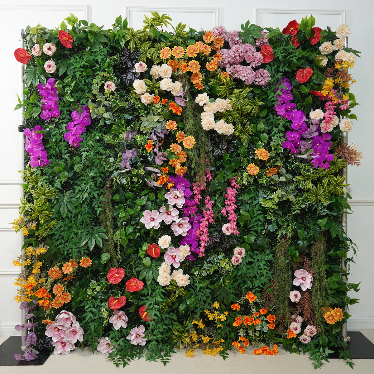 Outdoor photoshoot flower wall with bright mixed floral arrangement