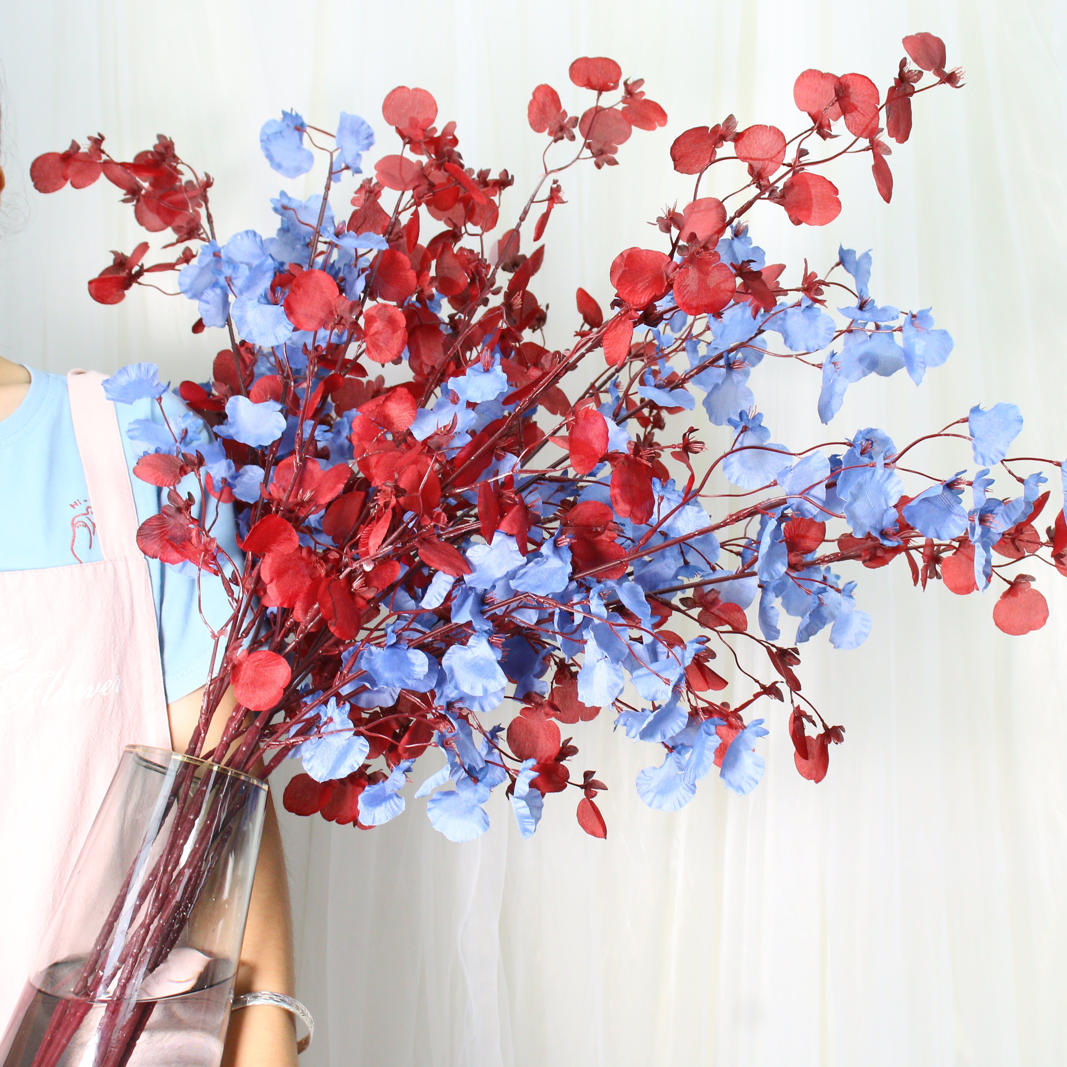 mixed‑red‑blue‑fake‑orchid‑spray‑indoor‑table‑scene