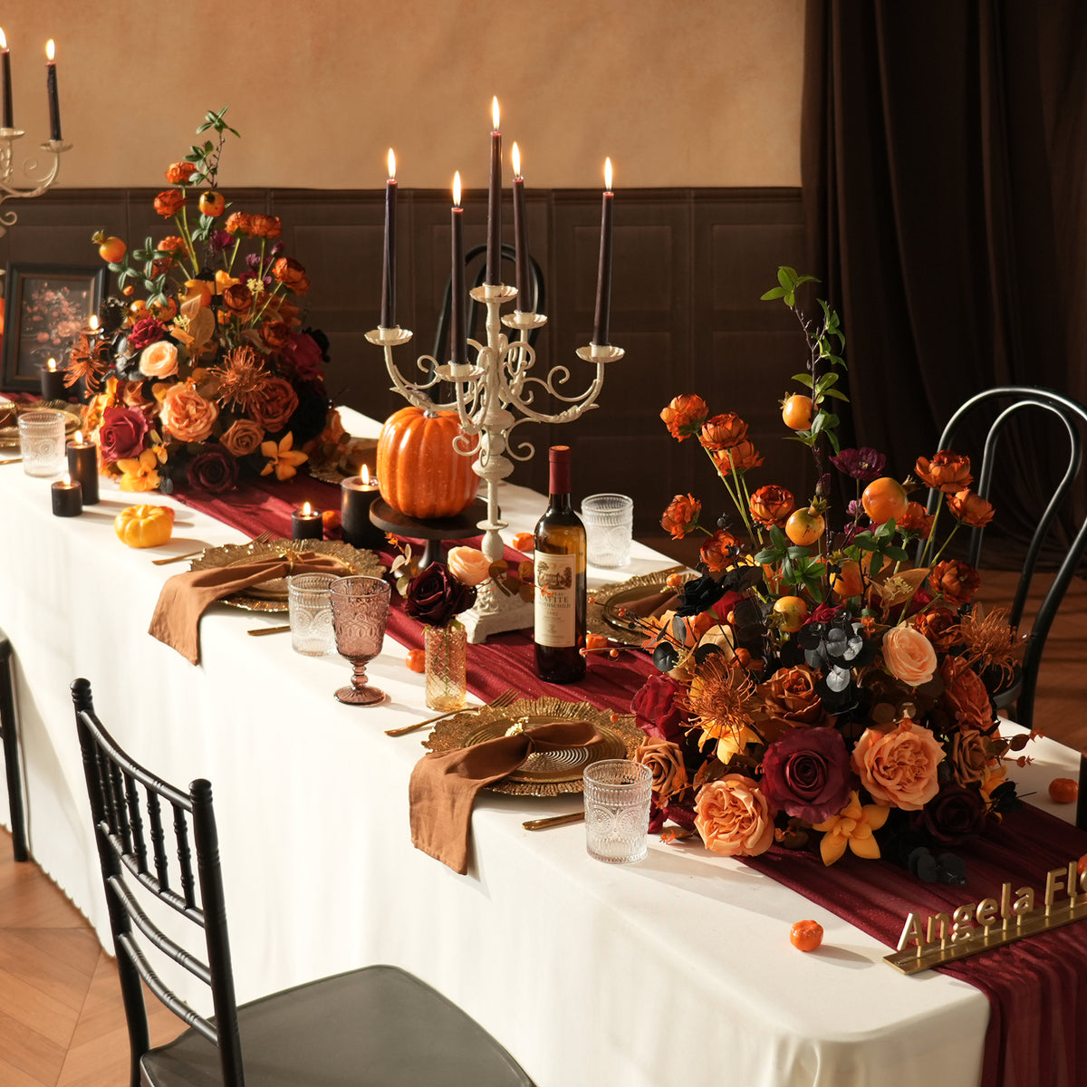 Black eucalyptus mixed with orange roses halloween arrangement