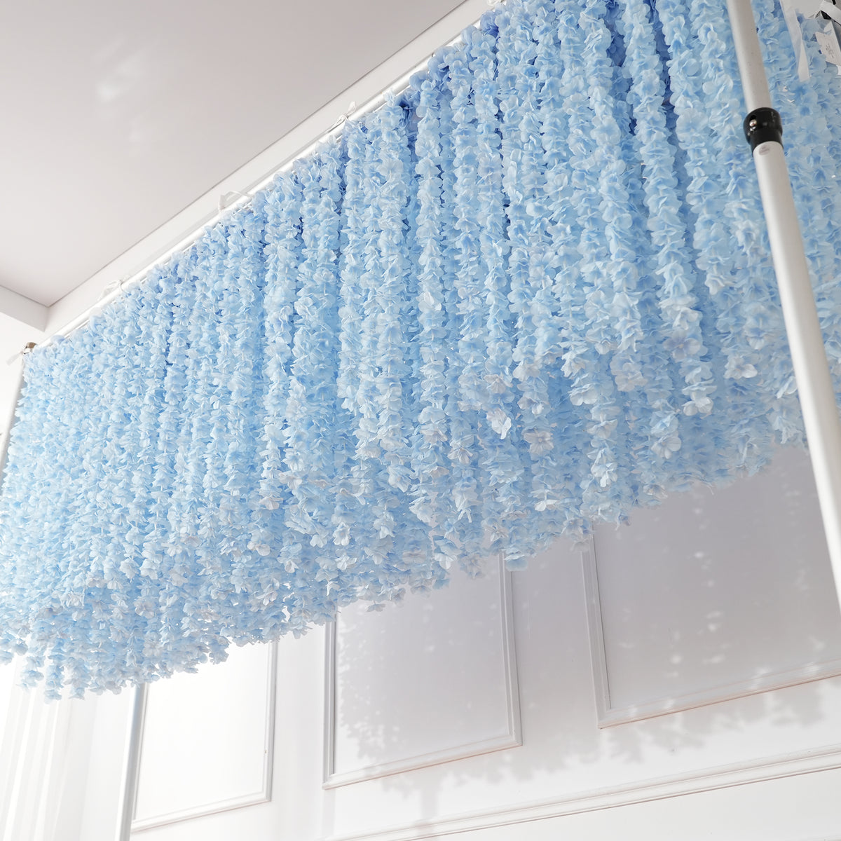 Installed wisteria hanging flower curtain with metal backdrop stand