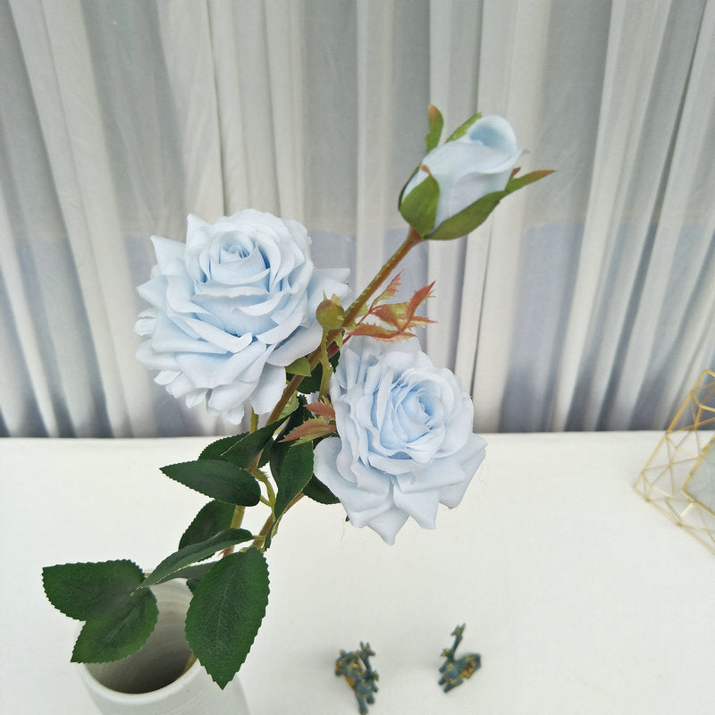 Pastel blue silk rose with green leaves