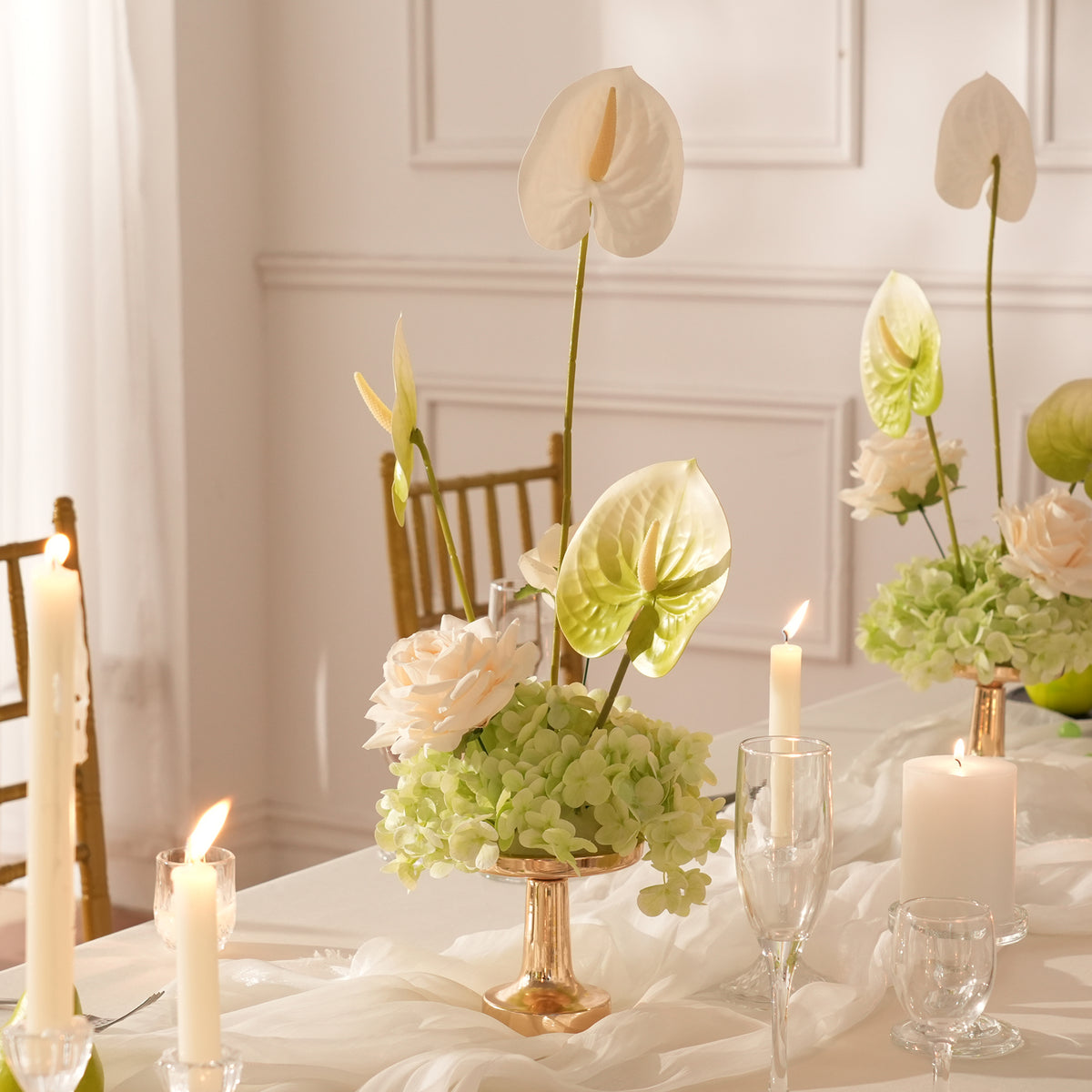 Artificial table centerpiece beside glass candle lamp home styling
