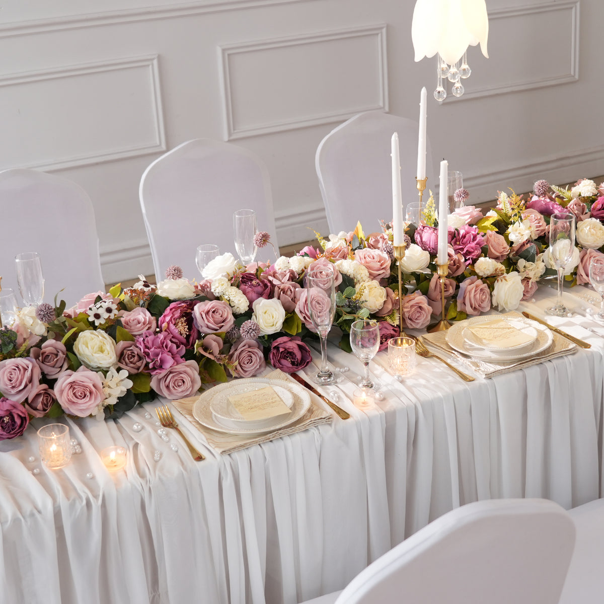 Indoor banquet wedding tablescape with long trailing mauve purple flower runner