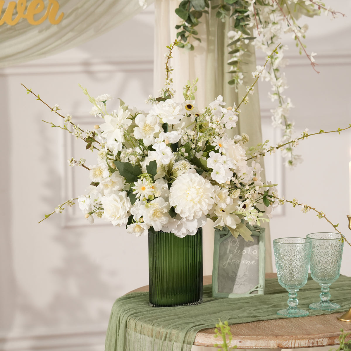 Wedding reception table flower arrangement with green foliage