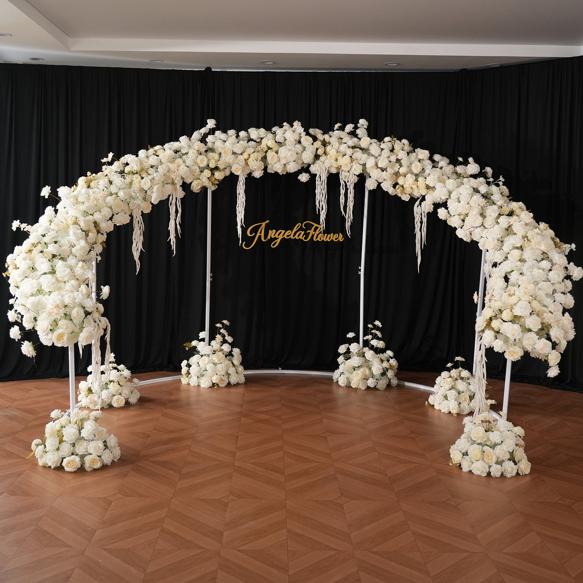 White rose arch paired with beige fabric draping wedding scene