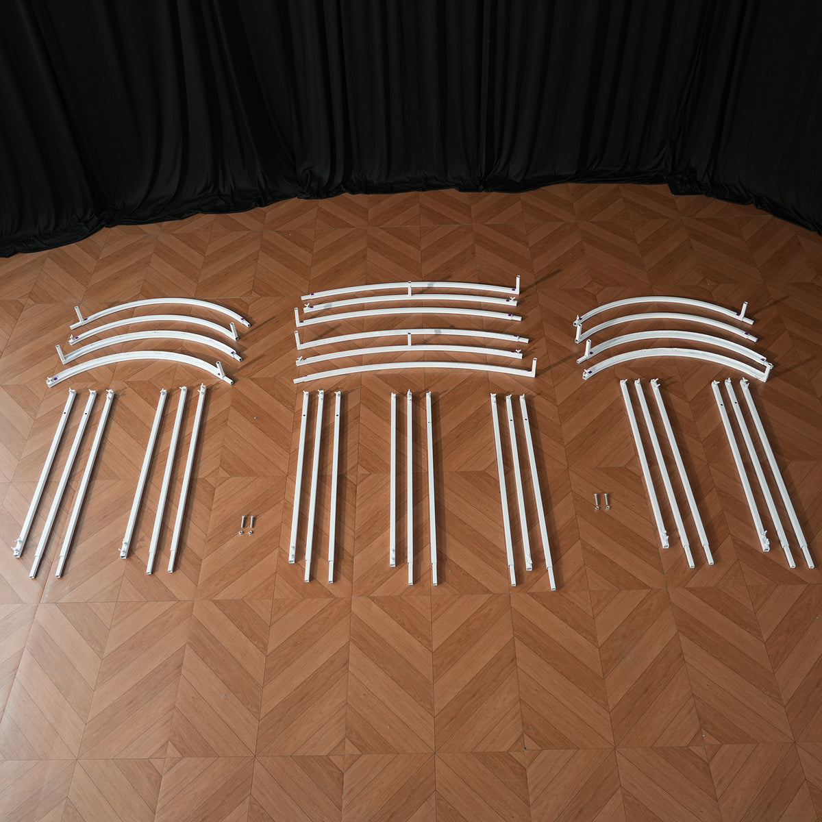 Curved backdrop frame assembly view, white metal pipe structure for event
