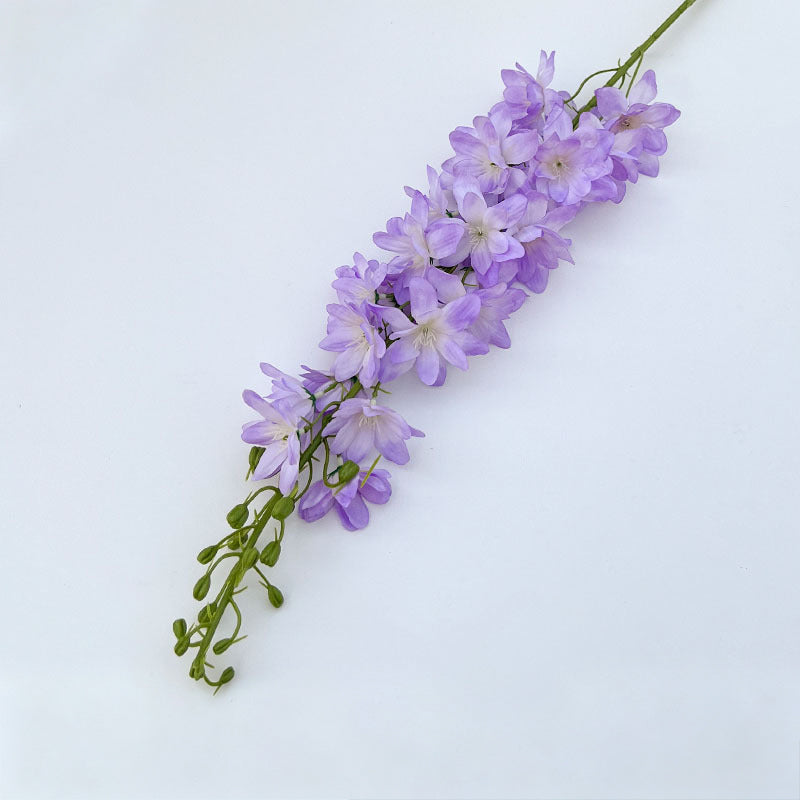 pastel‑blue‑fake‑larkspur‑delphinium‑sprigs‑white‑backdrop‑shot