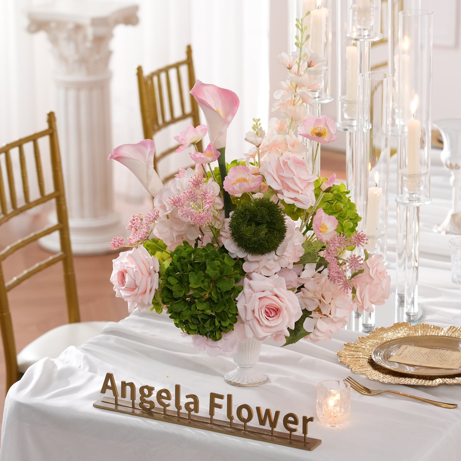 Long wedding dinner table styled with blush pink faux floral arrangements