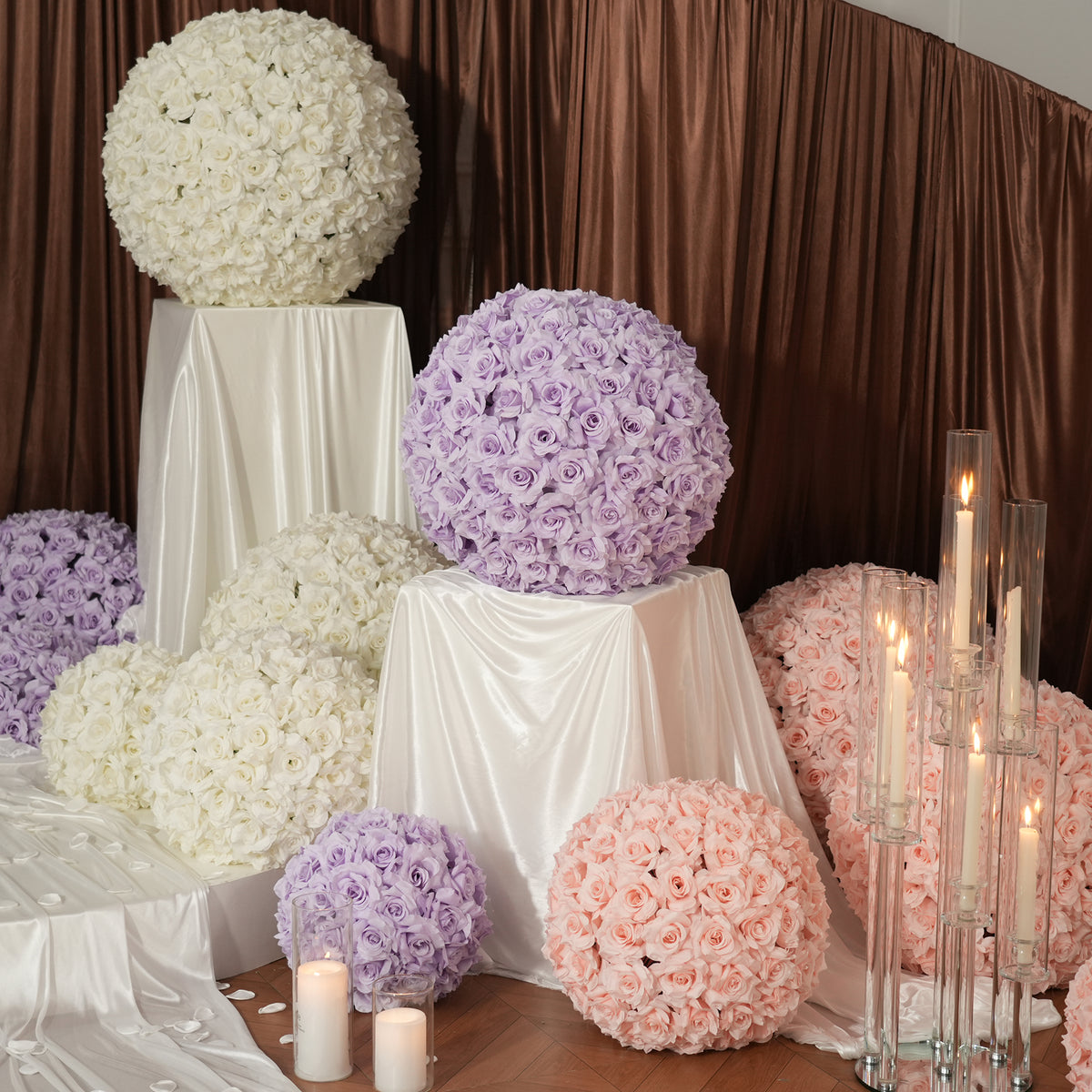 Rose flower spheres arranged on herringbone wooden floor