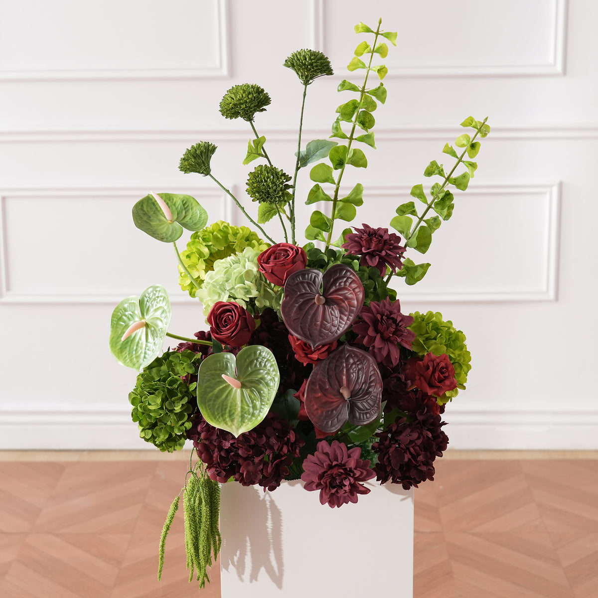 Bright orange gerbera mixed greenery table flower arrangement