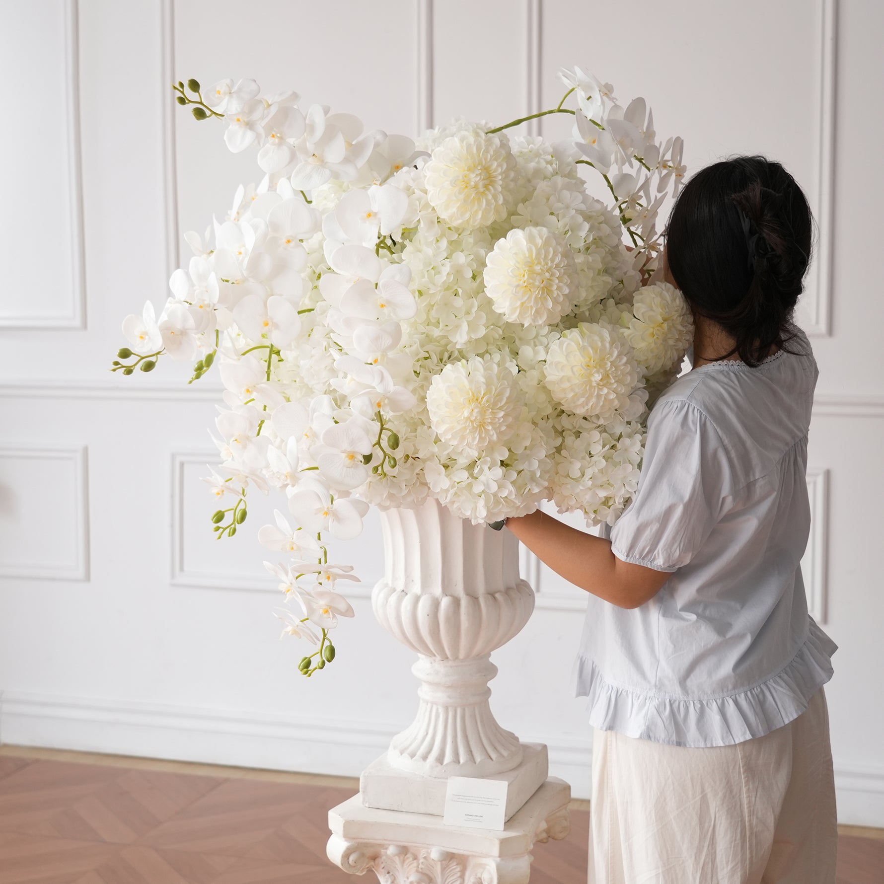 White Wedding Reception Table Decor With Tall Floral Arrangement