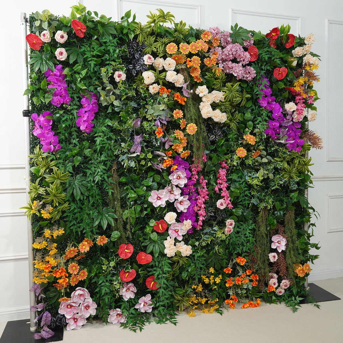Dense greenery base flower wall with pop colorful blooms