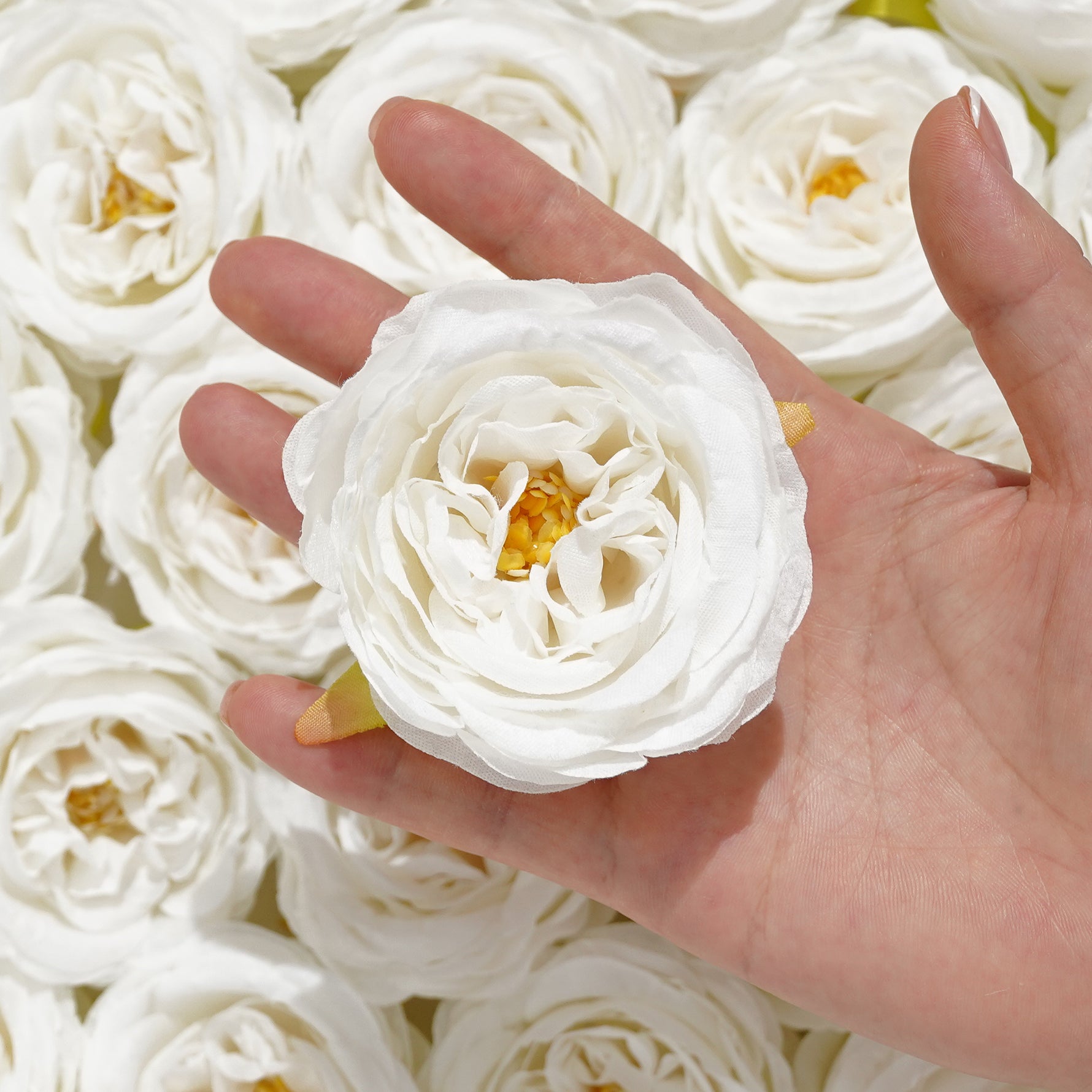 Multi tone silk rose flower heads styling flat lay
