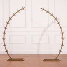 empty golden circular metal wedding arch frame on wood floor
