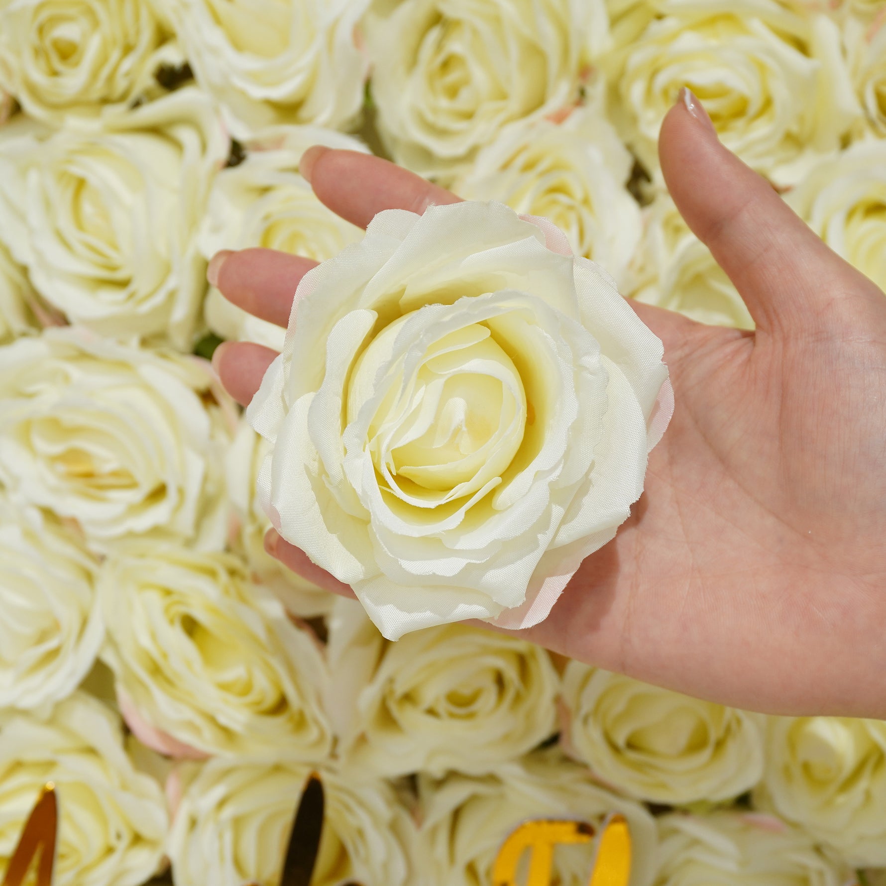 Unstemmed artificial rose bloom