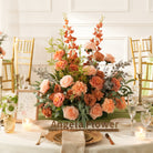 Warm tone silk rose and textured greenery bouquet designed as wedding table centerpieces