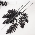 Gothic black silk flower branches arranged in glass vase