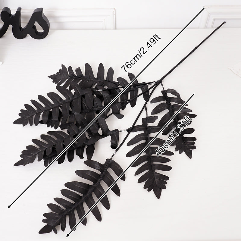 Gothic black silk flower branches arranged in glass vase