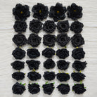 Dark faux flower heads for moody wedding backdrop