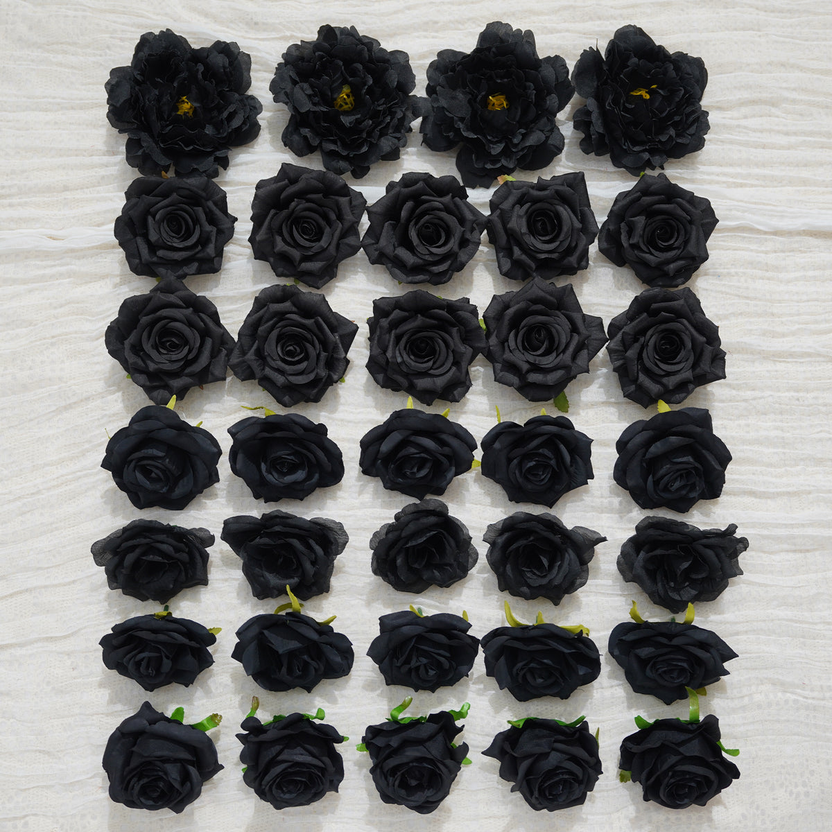 Dark faux flower heads for moody wedding backdrop