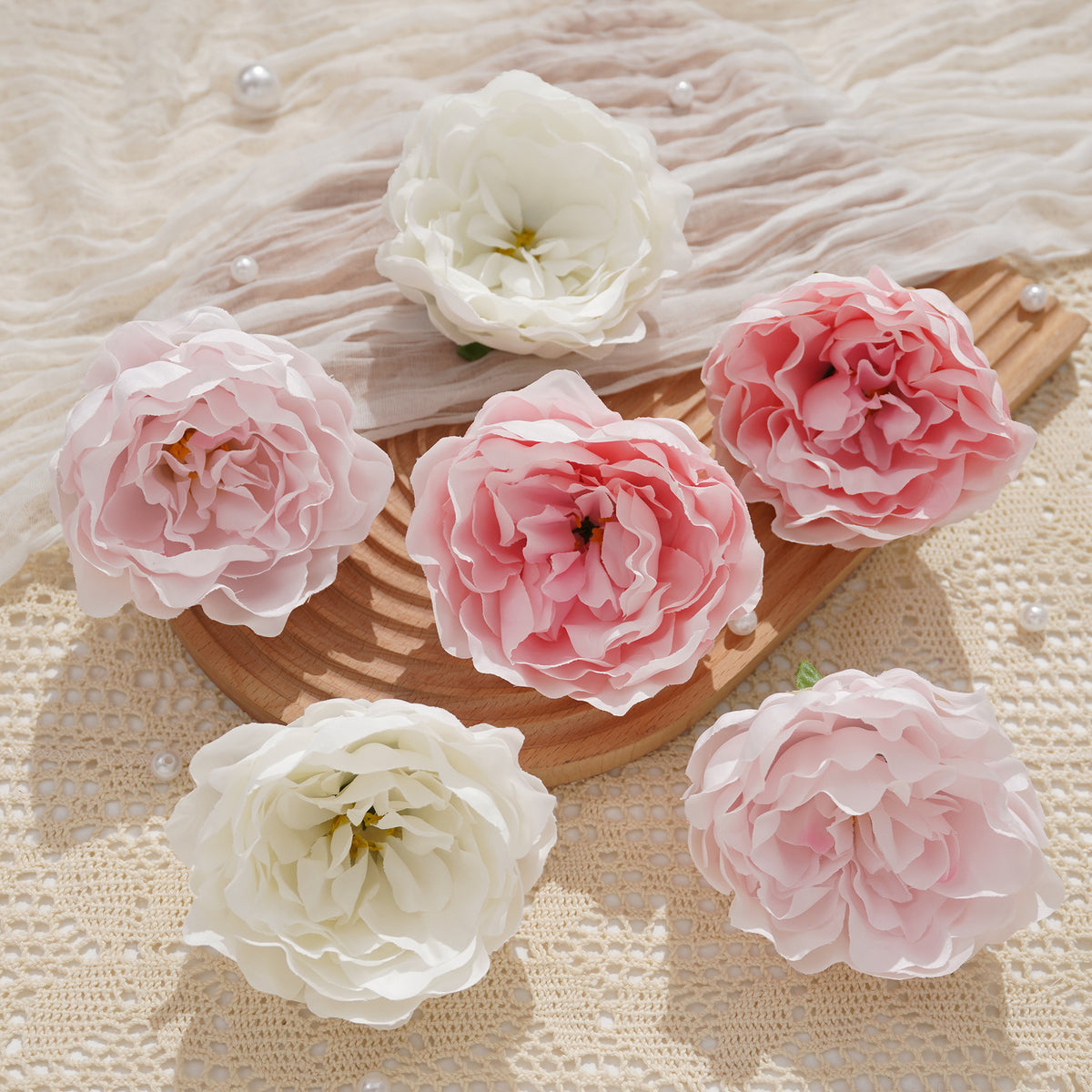 Blush pink peony heads on linen background