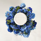Closeup of royal blue mixed artificial flower wedding table centerpiece