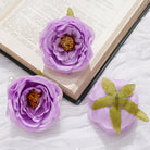 Purple artificial rose heads event floral arrangement