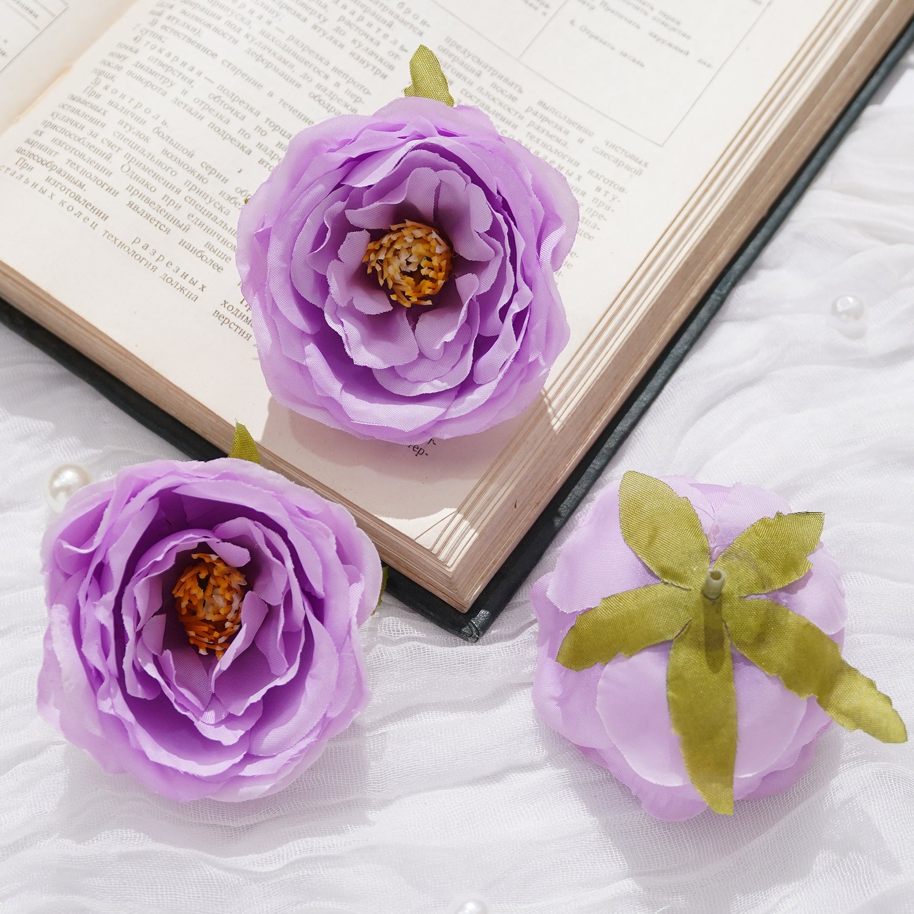 Purple artificial rose heads event floral arrangement
