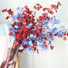 mixed‑red‑blue‑fake‑orchid‑spray‑indoor‑table‑scene