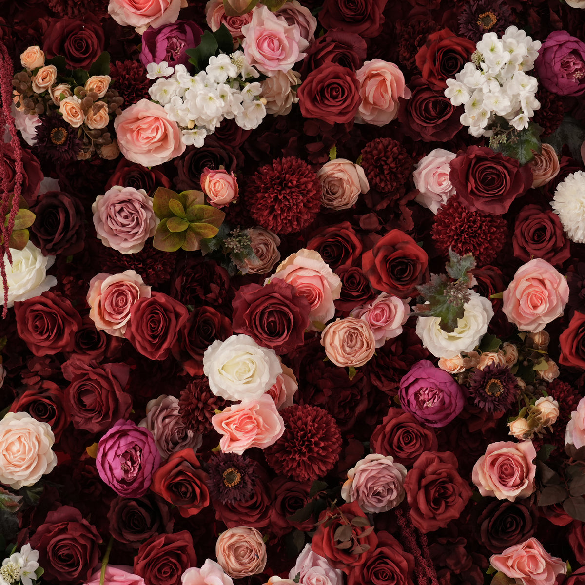 Burgundy floral backdrop paired with pillar candle decor