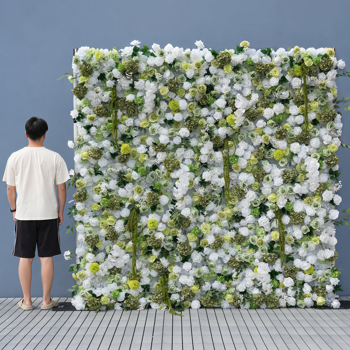 Elegant ivory‑green faux floral backdrop wall, textured mixed blooms for wedding reception and party photo setup