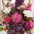 lush‑dark‑purple‑hydrangea‑faux‑table‑flowers‑indoor‑wedding‑ceremony‑shot