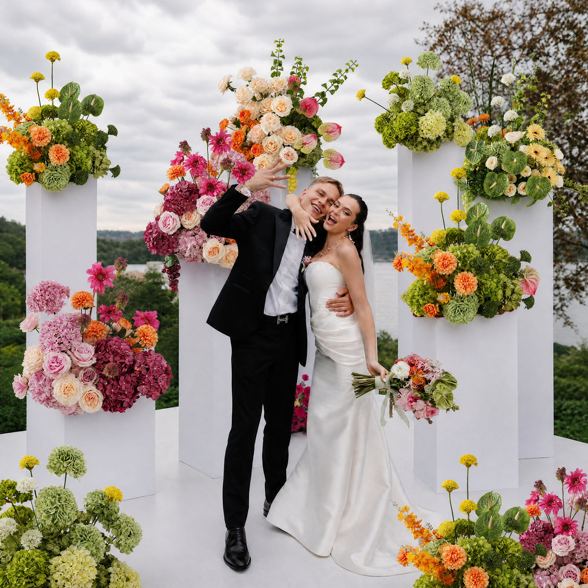 Wedding couple portrait with bright colorful table floral arrangements