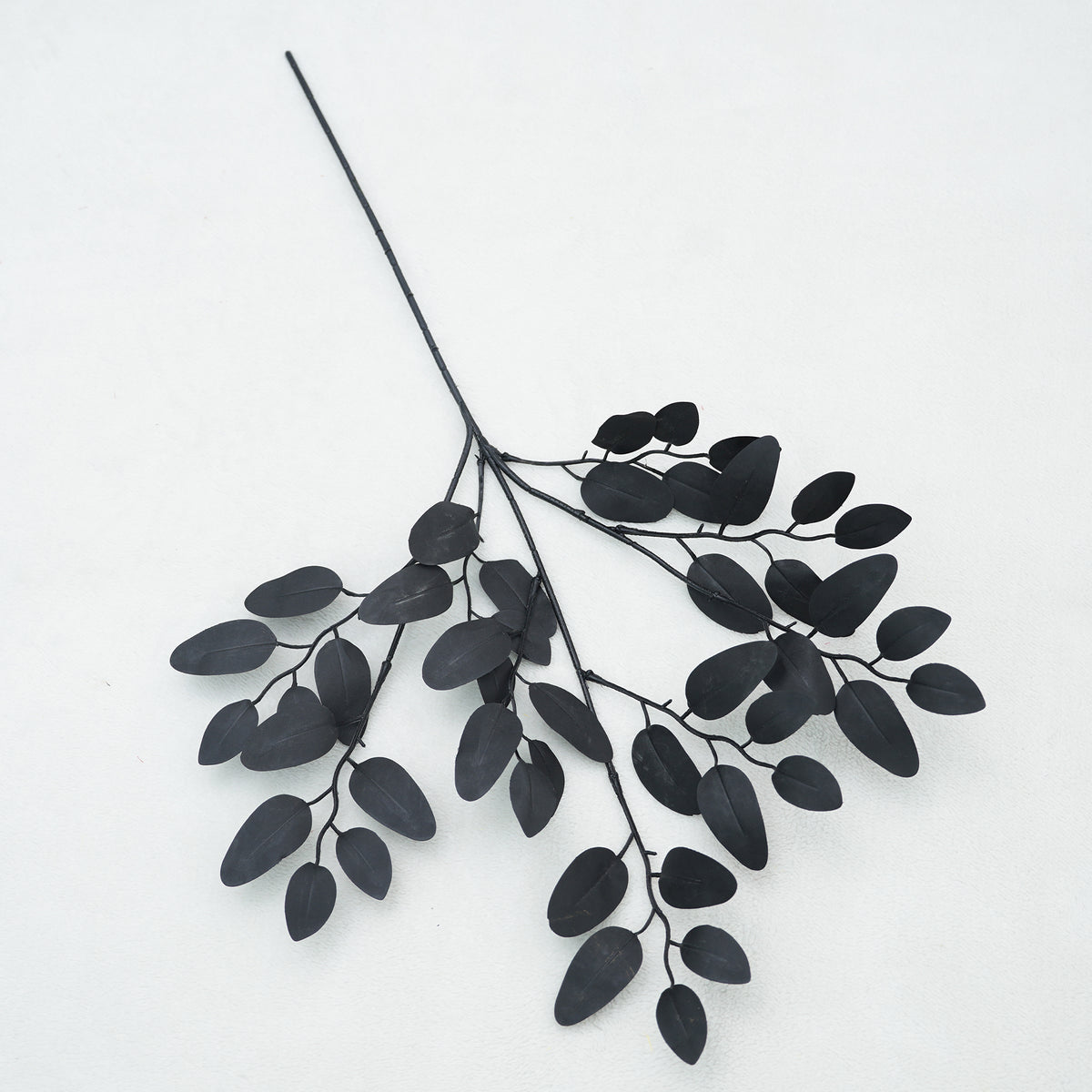 Isolated dark artificial leaves single stem product shot