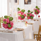 single‑pink‑artificial‑table‑centerpiece‑close‑up‑wedding‑reception‑scene