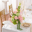 Indoor close‑up view of mixed silk flower vase table centerpiece display
