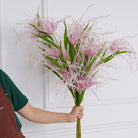 faux‑beauty‑silk‑flower‑sprigs‑pastel‑pink‑studio‑white‑wall‑background
