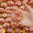 pale_peach_faux_rose_blooms_hand_held