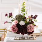Moody garden‑style silk floral centerpiece with bells of ireland and calla lily for wedding tables