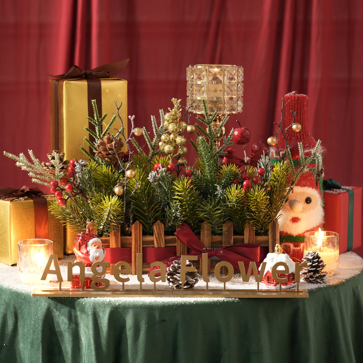 Close up of frosted artificial cedar branches, red berries and pine cones holiday greenery