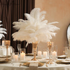 Full fluffy white ostrich feather display in gold pedestal vase