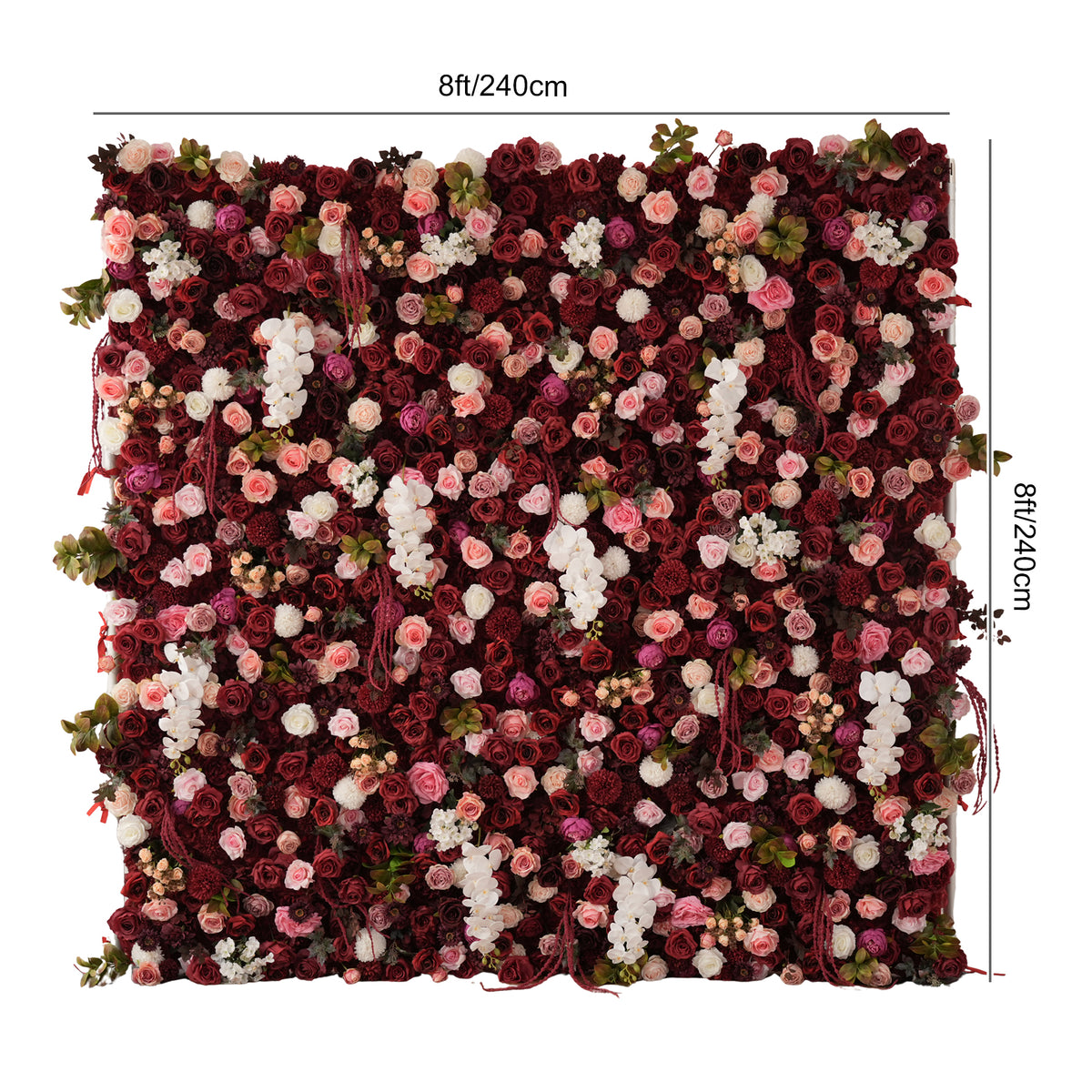 Close up of mixed blooms and greenery on flower wall