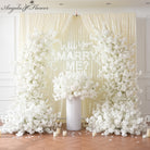 all white floral backdrop for marriage proposal